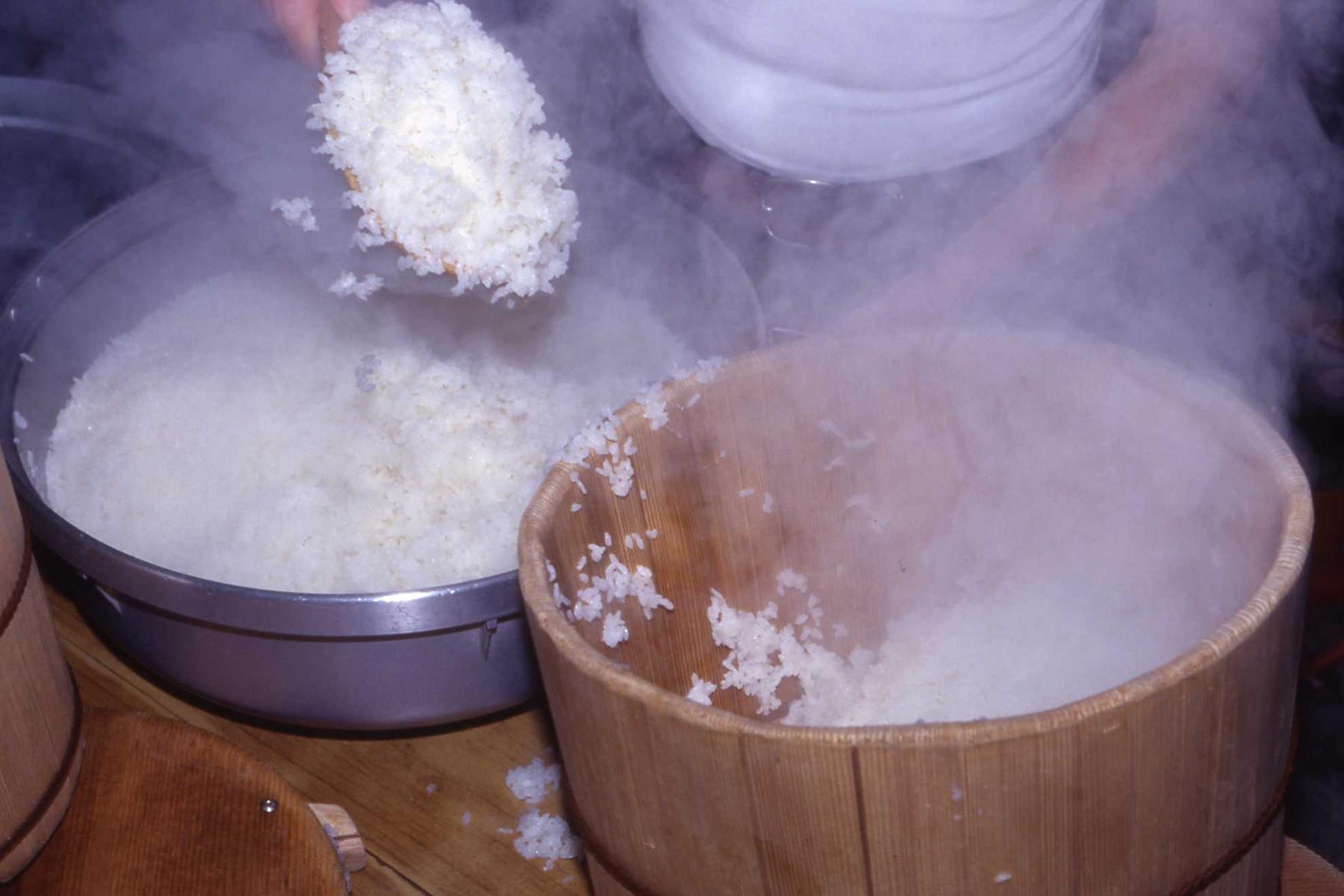 釜肌からしゃもじを入れてご飯をはずし、全体に混ぜながら吸水性の高いお櫃に移す。