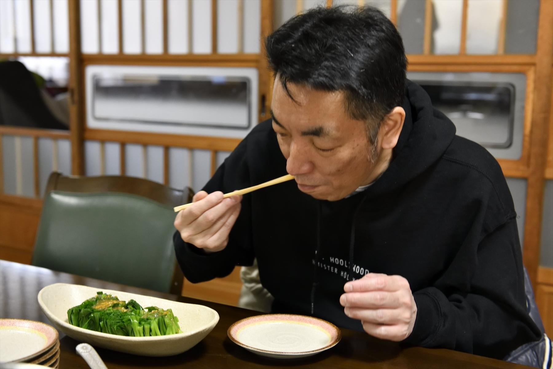 にら料理を食べる佐藤さん